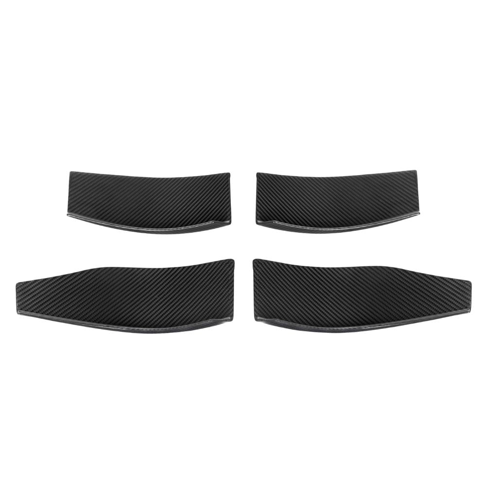 BMW M3 M4 G80 G82 G83 carbon fibre front bumper canards by CT Carbon, close-up of sleek, aerodynamic car accessory.