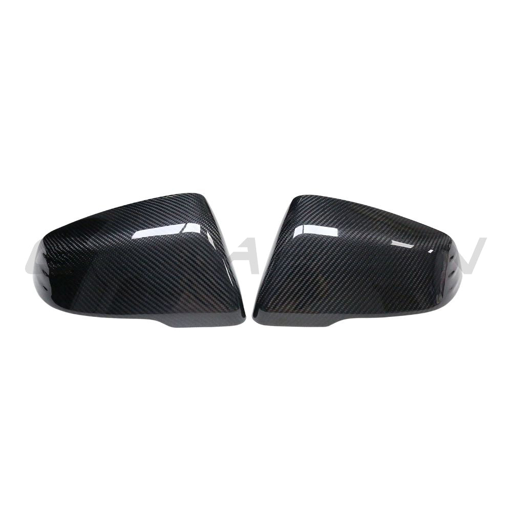 Toyota Supra A90 carbon fiber mirrors by CT Carbon, close-up of sleek, lightweight automotive accessories with textured carbon fiber finish.