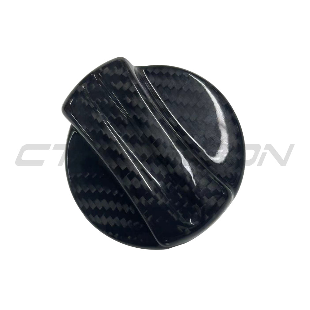 BMW 2010+ carbon fiber fuel cap cover by CT Carbon, close-up of sleek black carbon fiber finish on car accessory.