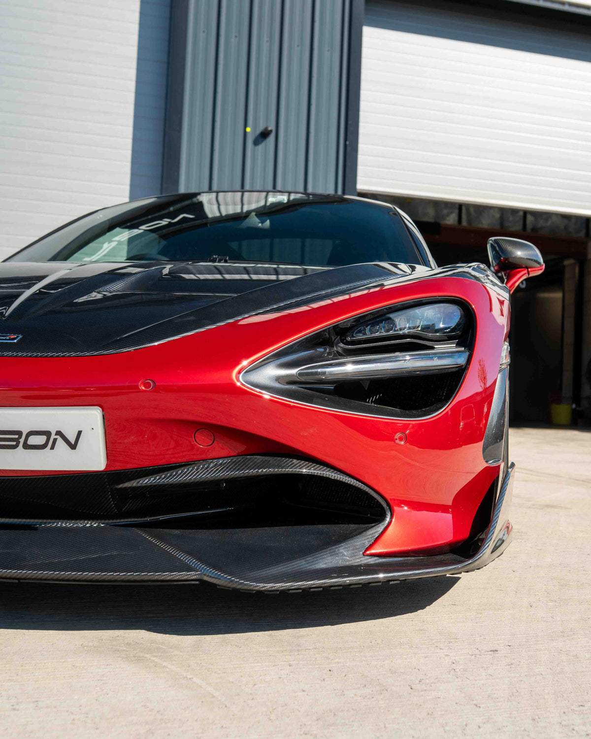 Carbon fiber splitter for McLaren 720S by CT Carbon, showing the sleek, aerodynamic design and textured finish.