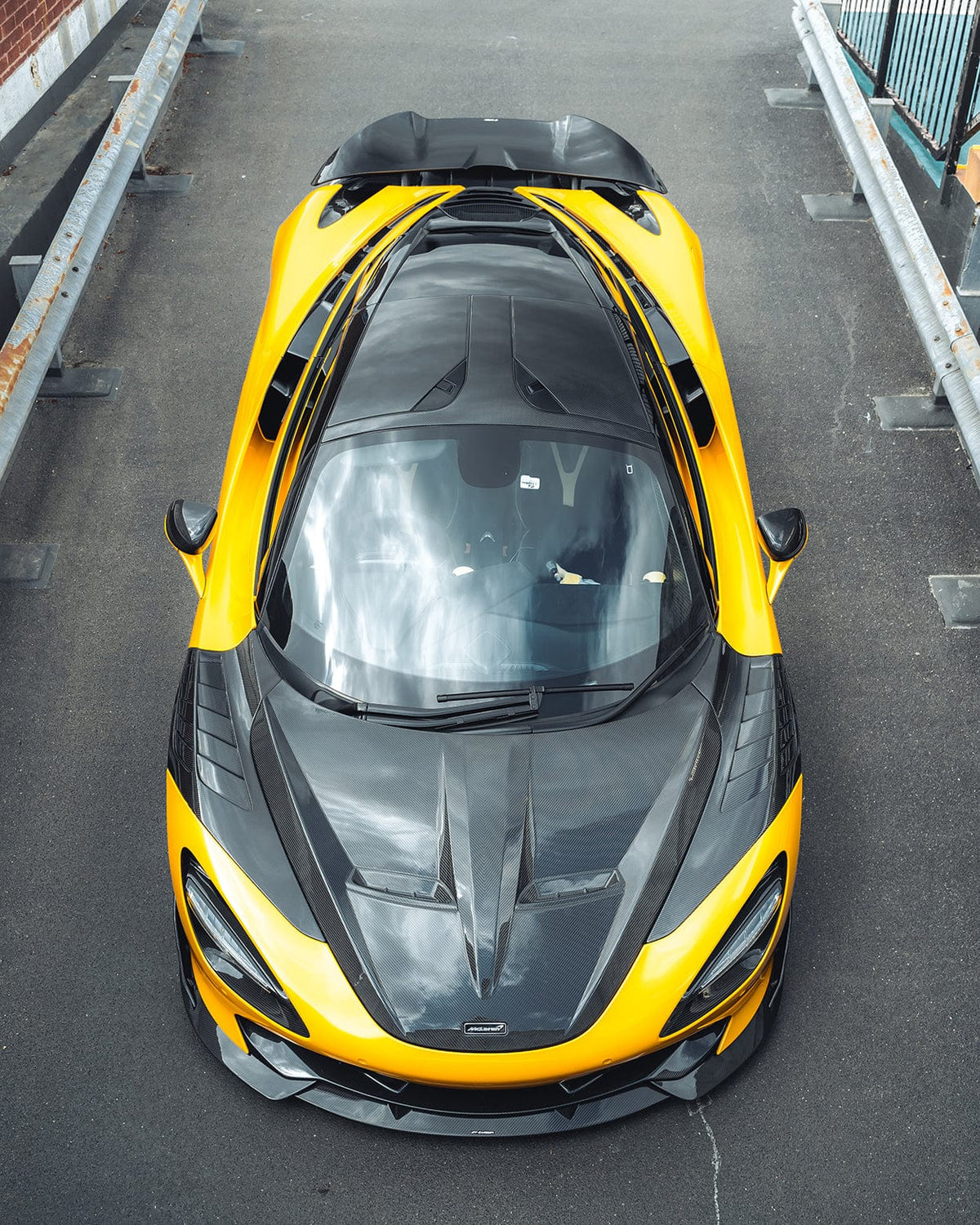 Full view of a McLaren 720S with CT Carbon full carbon fibre kit, showcasing sleek carbon fibre accents and aerodynamic design.