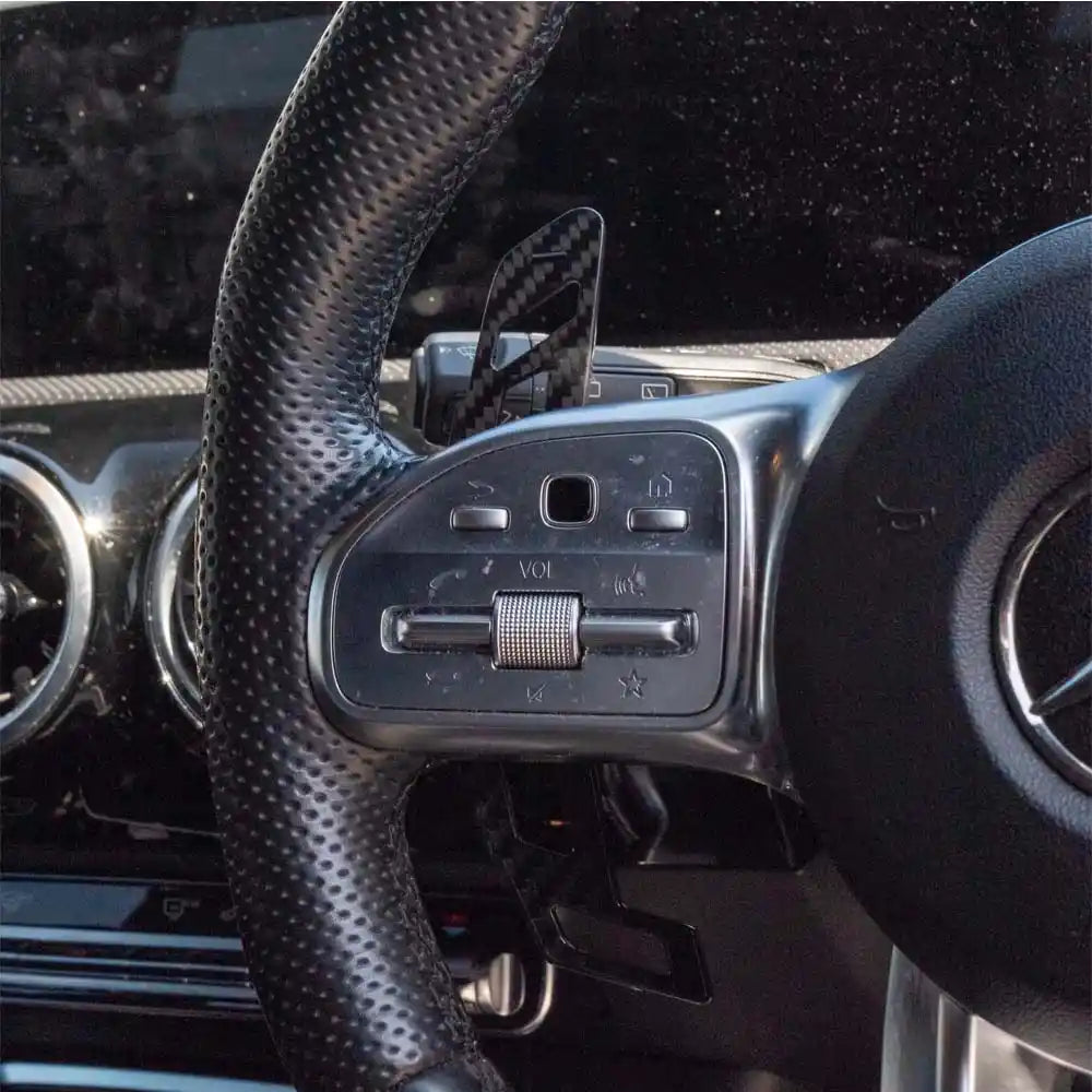 Mercedes AMG magnetic carbon fiber shifter paddles by CT Carbon, close-up view showing sleek black carbon fiber finish.