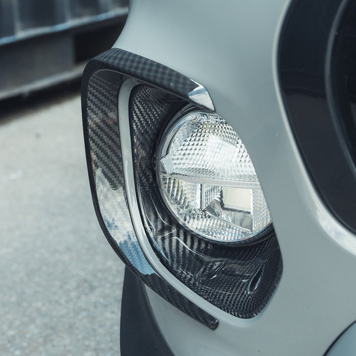 Pair of carbon fiber fog light covers for Mini Cooper S and JCW F56 by CT Carbon, designed to enhance vehicle appearance.