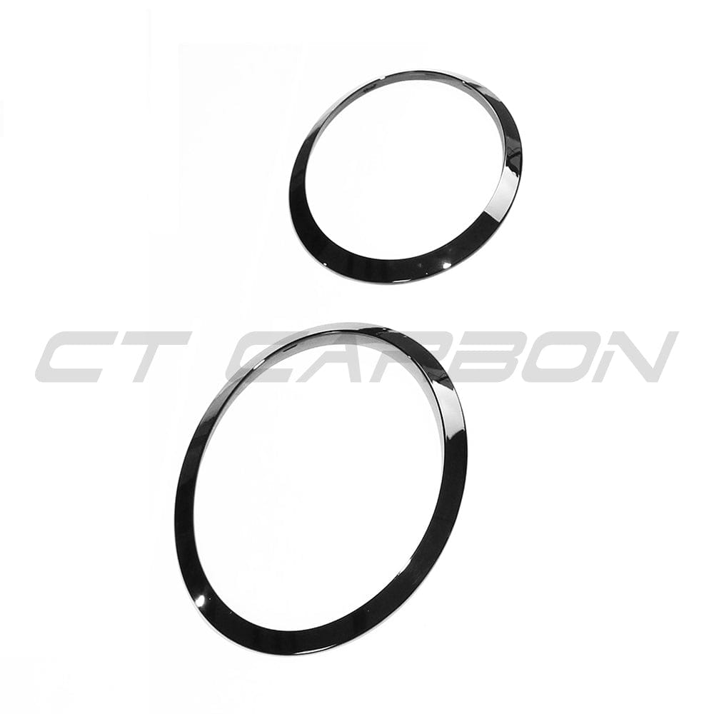 Close-up of a black gloss front light surround pack for MINI Cooper S and JCW F56 by CT Carbon, showing sleek accessory details.