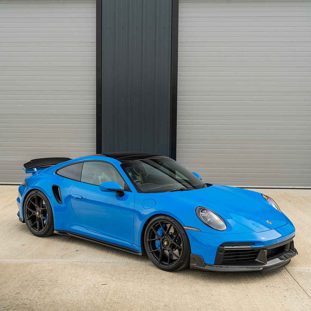 Porsche 911 (992) Turbo S carbon fibre front splitter and side skirts by CT Carbon, showcasing aerodynamic automotive accessories.