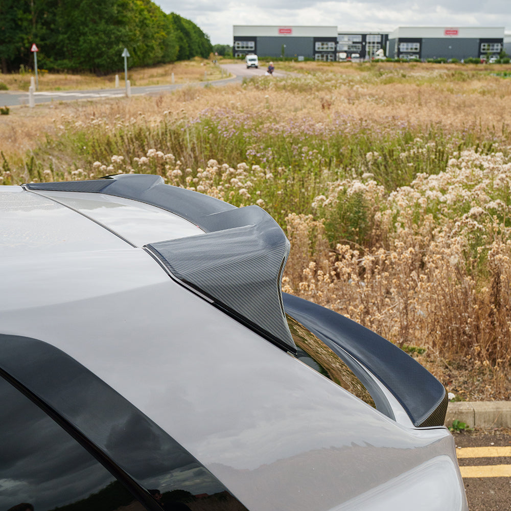 Rolls Royce Cullinan carbon fibre roof spoiler by CT Carbon, sleek aerodynamic car accessory on a luxury SUV.