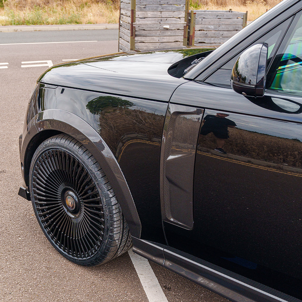 Range Rover L460 (SWB) 2022+ CT Carbon fiber kit showing sleek, glossy carbon fiber panels on the car's exterior.