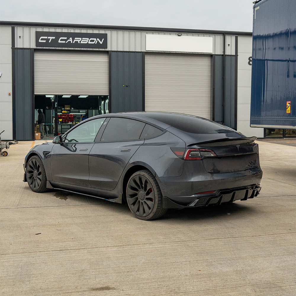 Tesla Model 3 full gloss black kit by CT Carbon, featuring sleek black exterior parts and finishes.