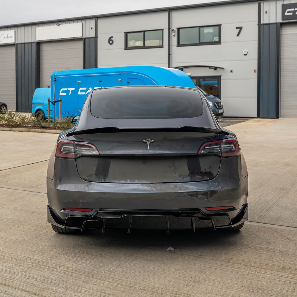 Tesla Model 3 full gloss black kit by CT Carbon, showcasing sleek black exterior accessories on the car.