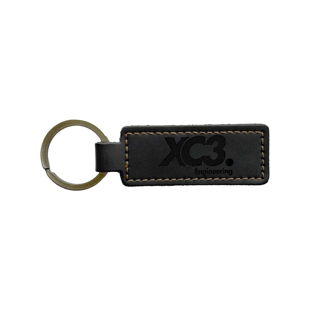 Black leather keyring by XC3 Engineering, durable and stylish accessory with a sleek finish and secure key attachment.