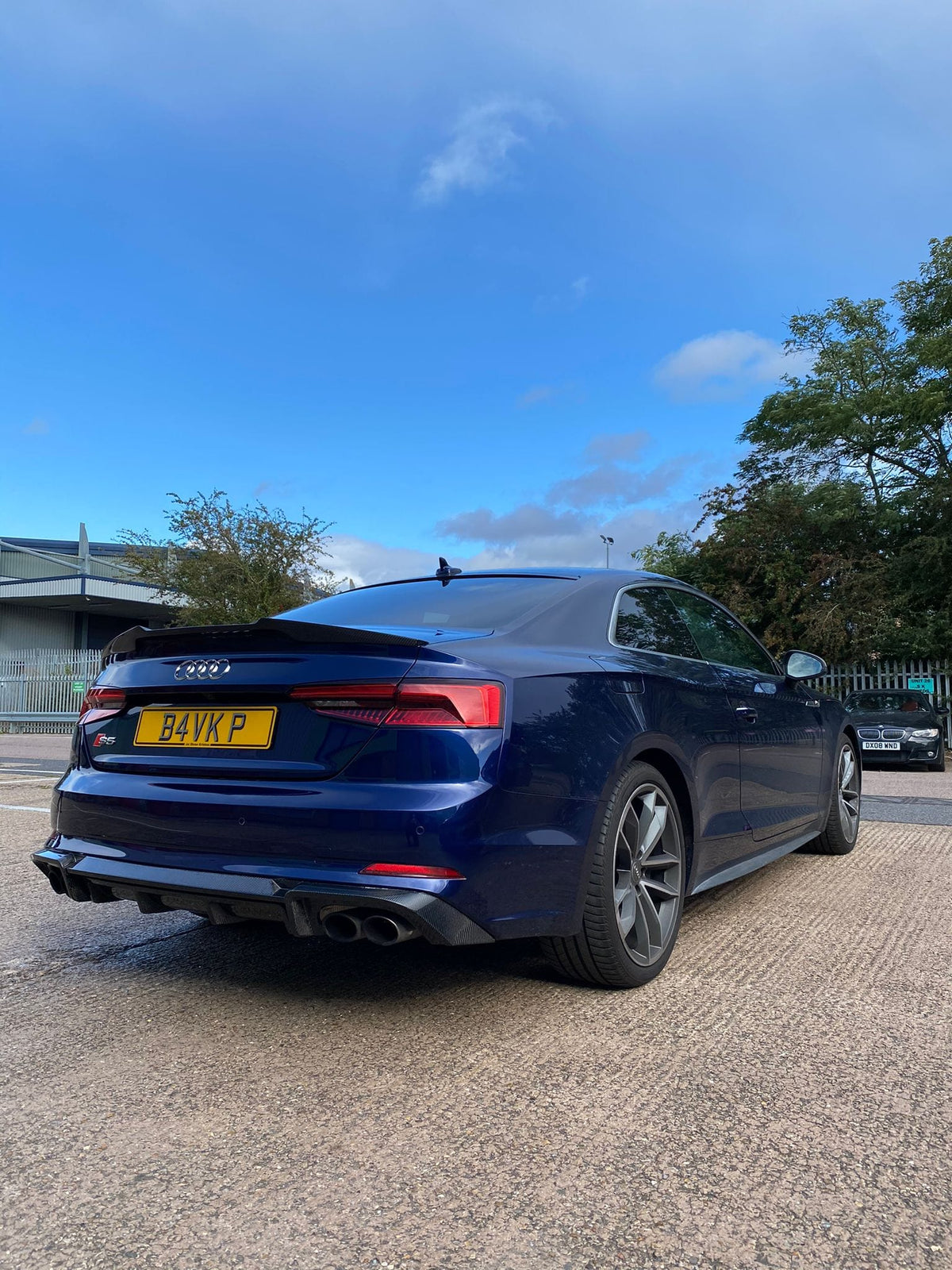 Carbon fiber diffuser for Audi A5 S5 B9 model by CT Carbon, showcasing its sleek, textured finish and aerodynamic design.