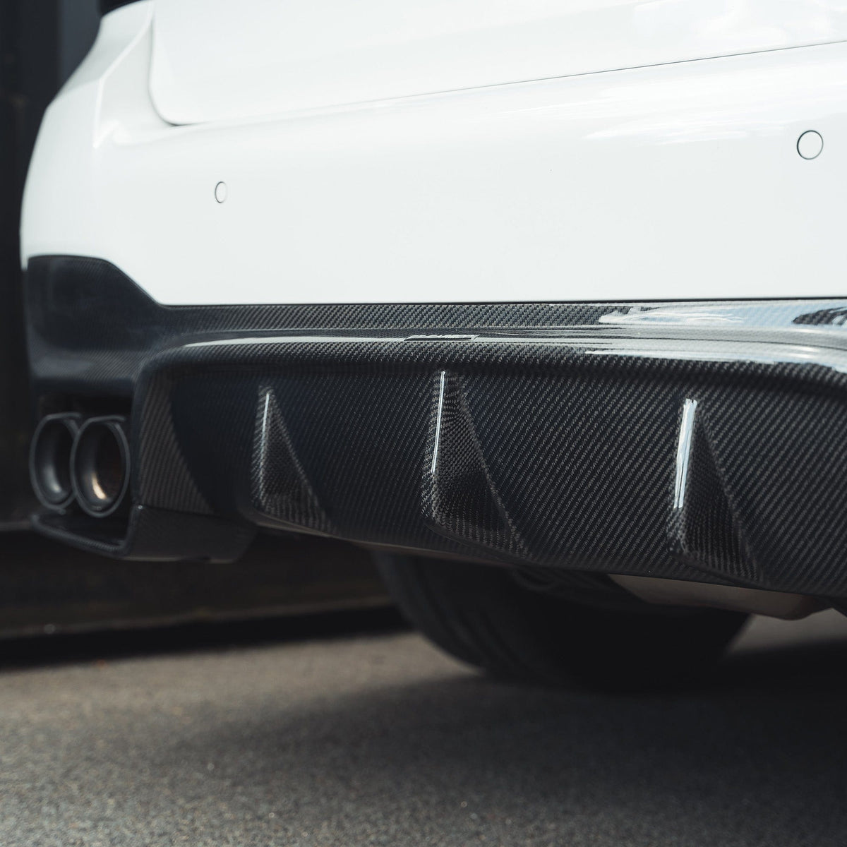 BMW F90 M5 CT Carbon fiber diffuser, V2 style, showcasing sleek carbon fiber material and aerodynamic design details.