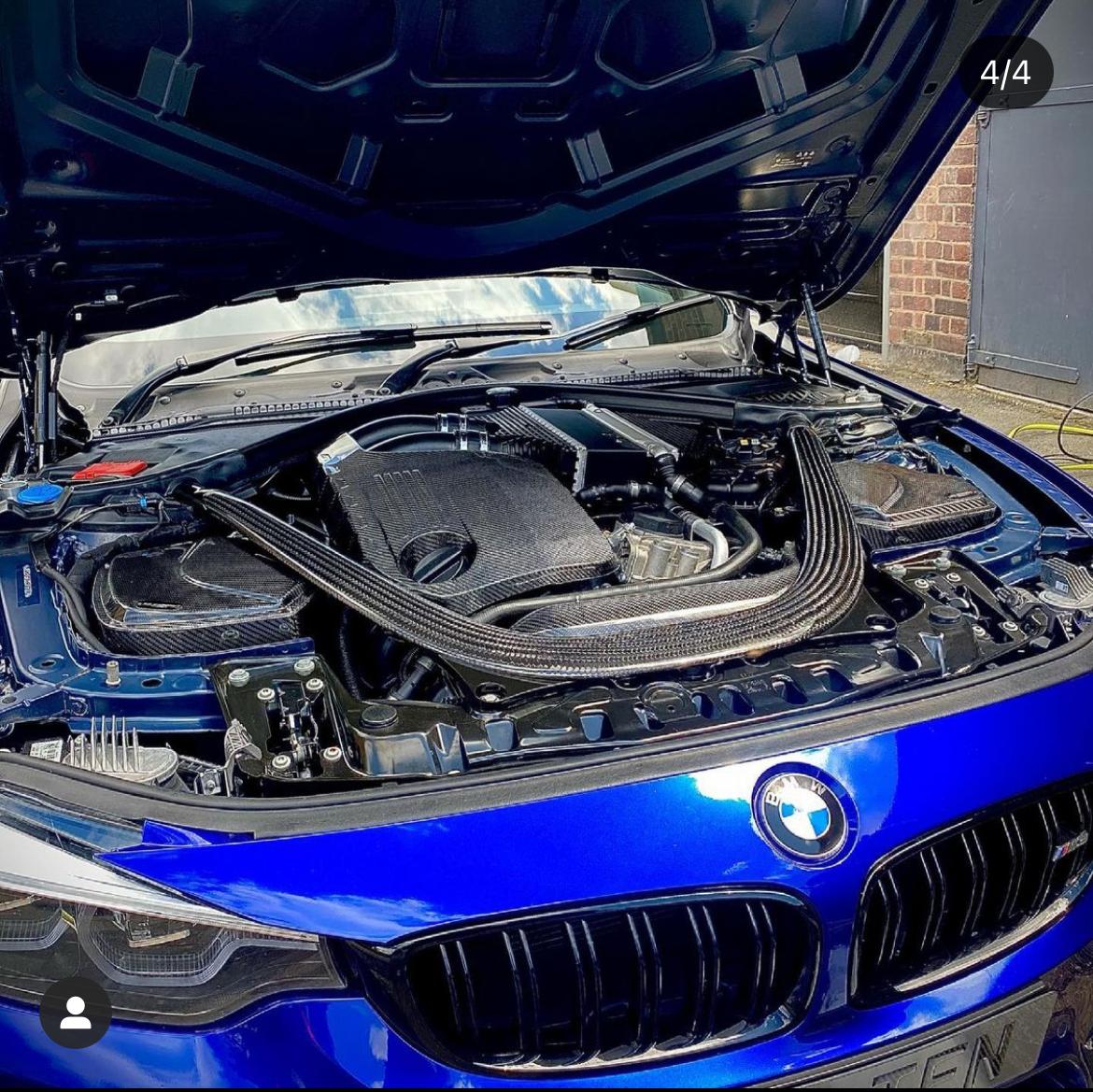 Carbon fibre engine cover for BMW F80, F82, F83, F87 M2C, M3, M4 by CT Carbon, showing the sleek textured surface and branding details.
