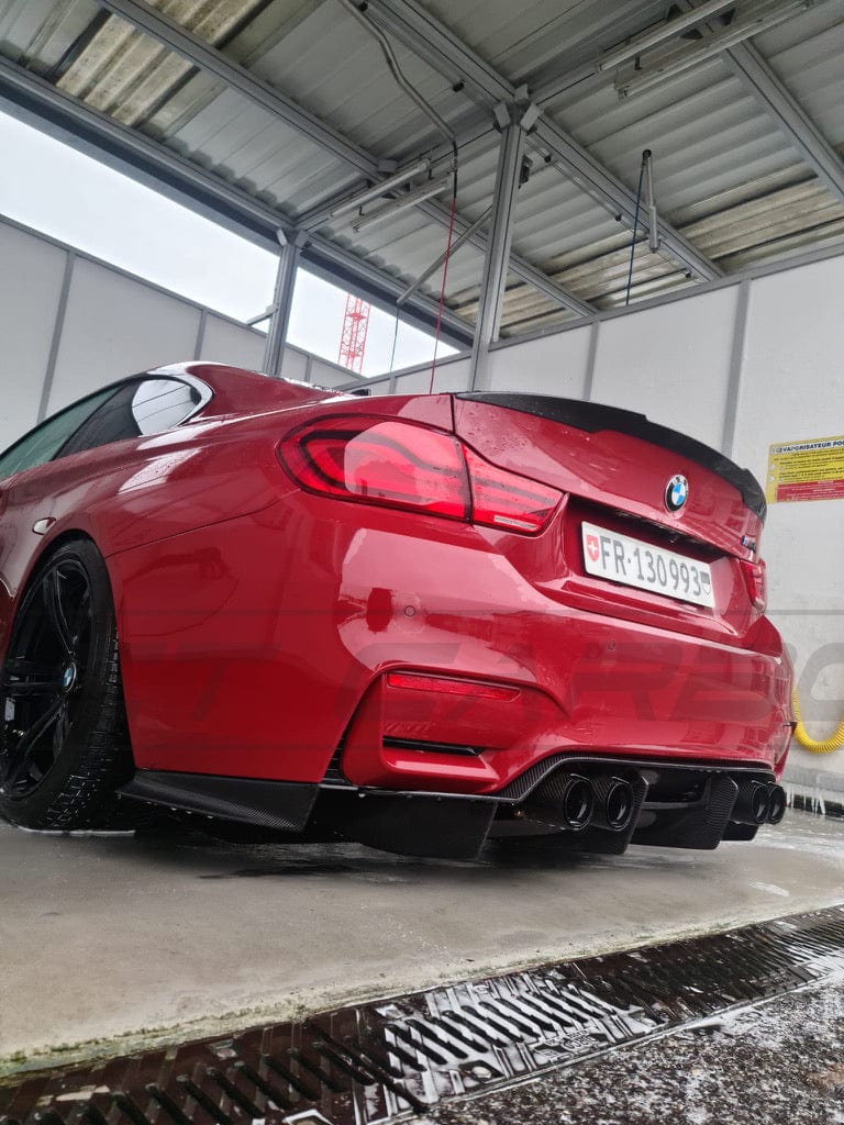 BMW M3 M4 F80 F82 F83 carbon fibre diffuser by CT Carbon, showcasing sleek, lightweight performance-enhancing automotive design.