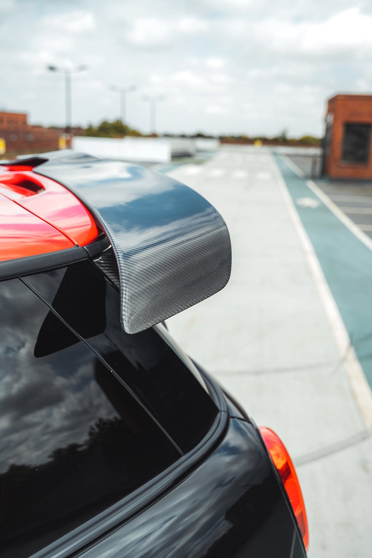Mini Cooper S F56 JCW Sport Pack carbon fiber spoiler by CT Carbon, showing the sleek, aerodynamic design on the car.
