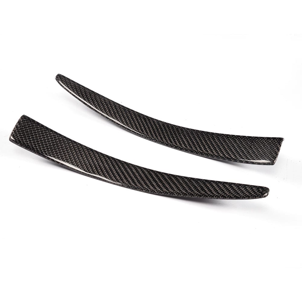 BMW M3 M4 F80 F82 F83 carbon fibre canard fins by CT Carbon, close-up of aerodynamic front canard fins on vehicle.