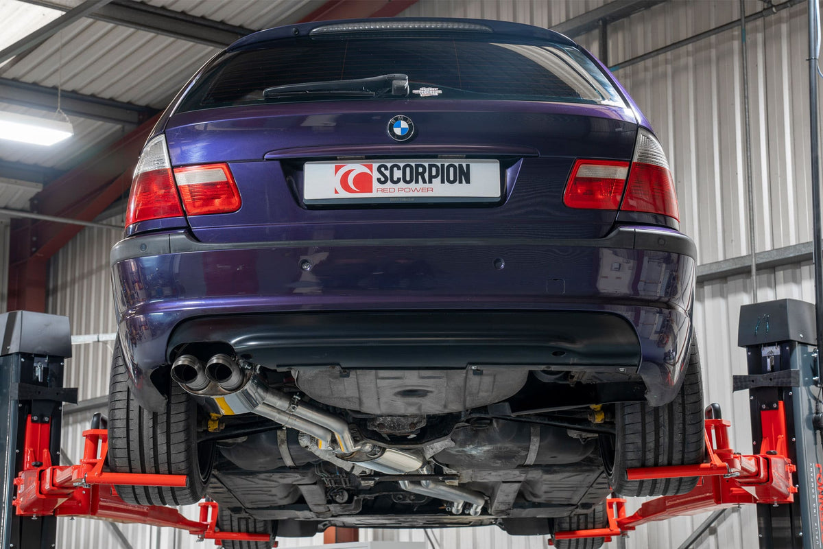 Scorpion BMW E46 cat-back exhaust system installed on a coupe, showing the polished metal pipes and muffler details.