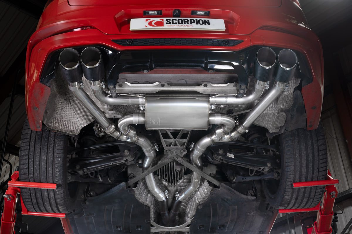 Scorpion BMW X4 M half exhaust system with valves, showing polished metal pipes and dual exhaust tips on a black vehicle.