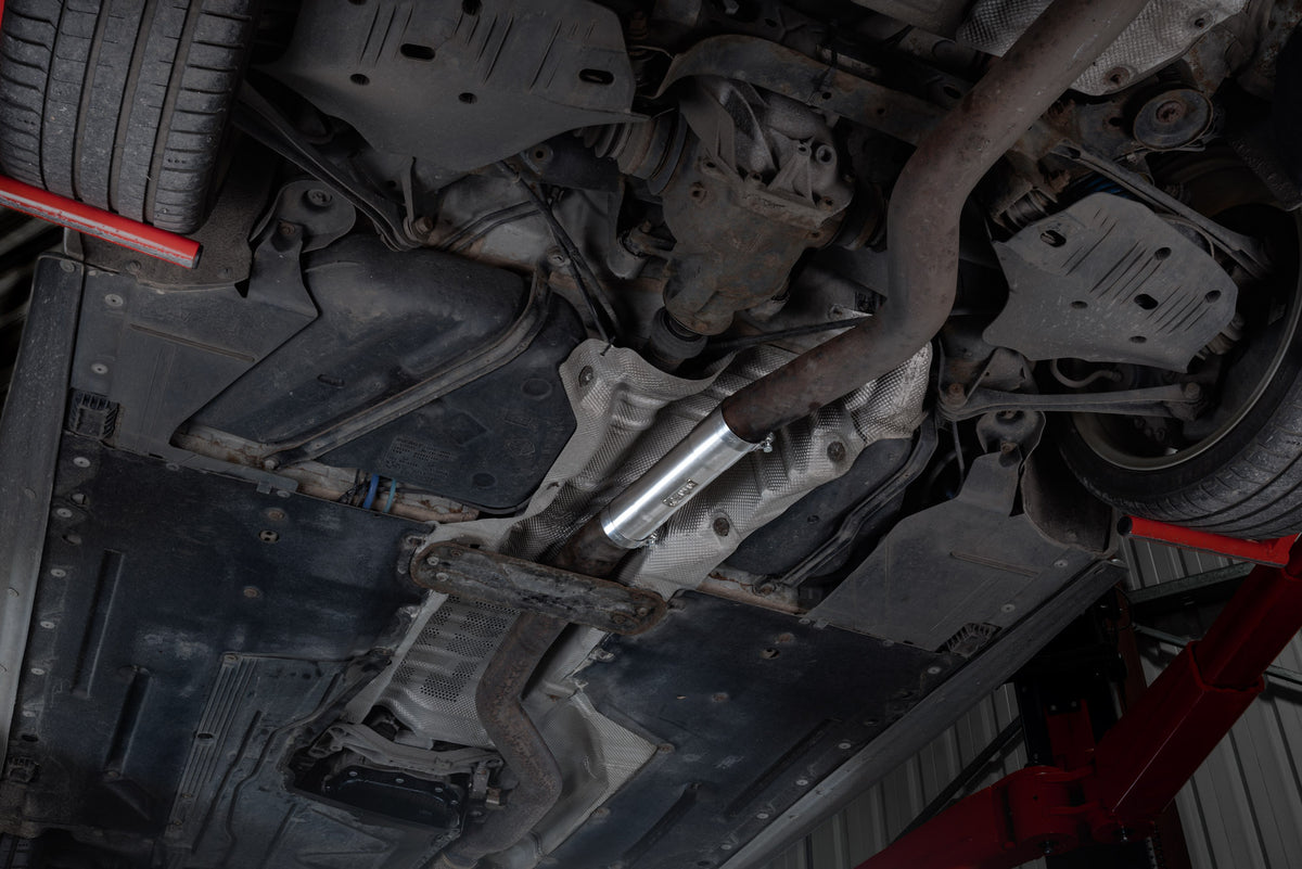Scorpion BMW M135i and M235i OEM resonator delete pipe installed on the exhaust system, showcasing the stainless steel pipe.