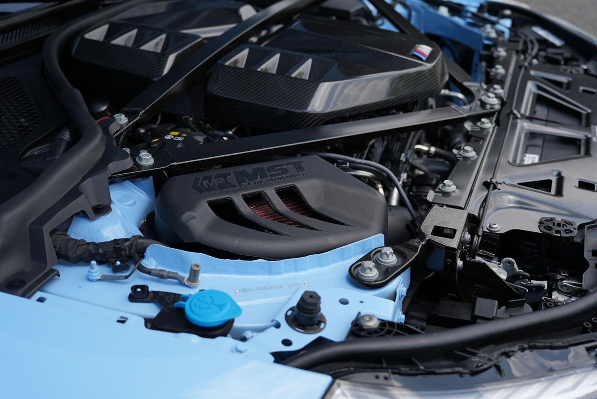 MST Performance induction kit for BMW G80 G82 M3 M4 Competition with S58 engine, showing the intake components and filter.
