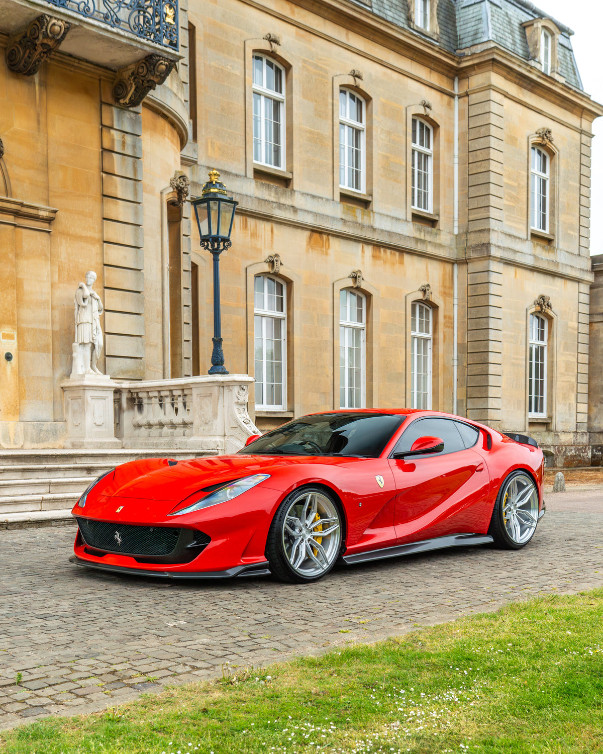 Ferrari 812 Superfast carbon fiber splitter kit by CT Design, showcasing detailed carbon fiber textured surface on the car's front.