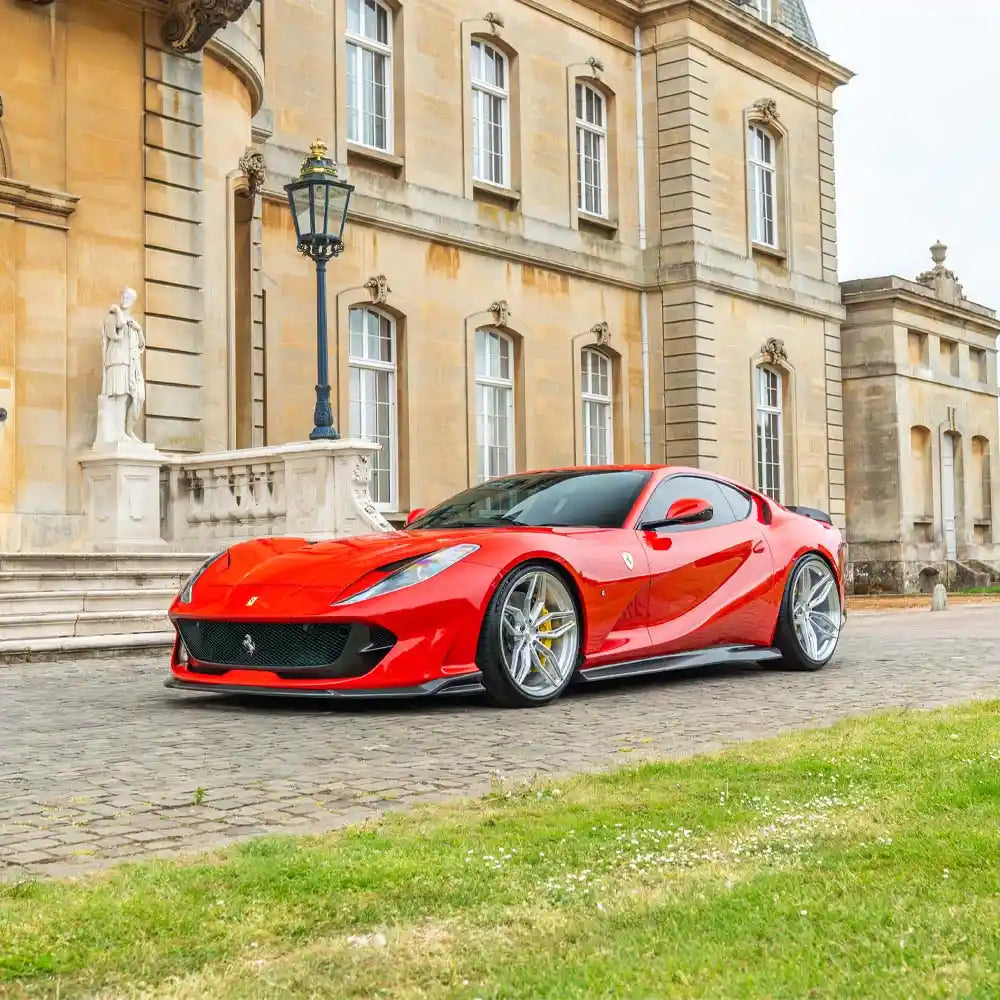 Ferrari 812 Superfast GTS carbon fiber side skirt extension by CT Carbon, showing sleek black aerodynamic design.